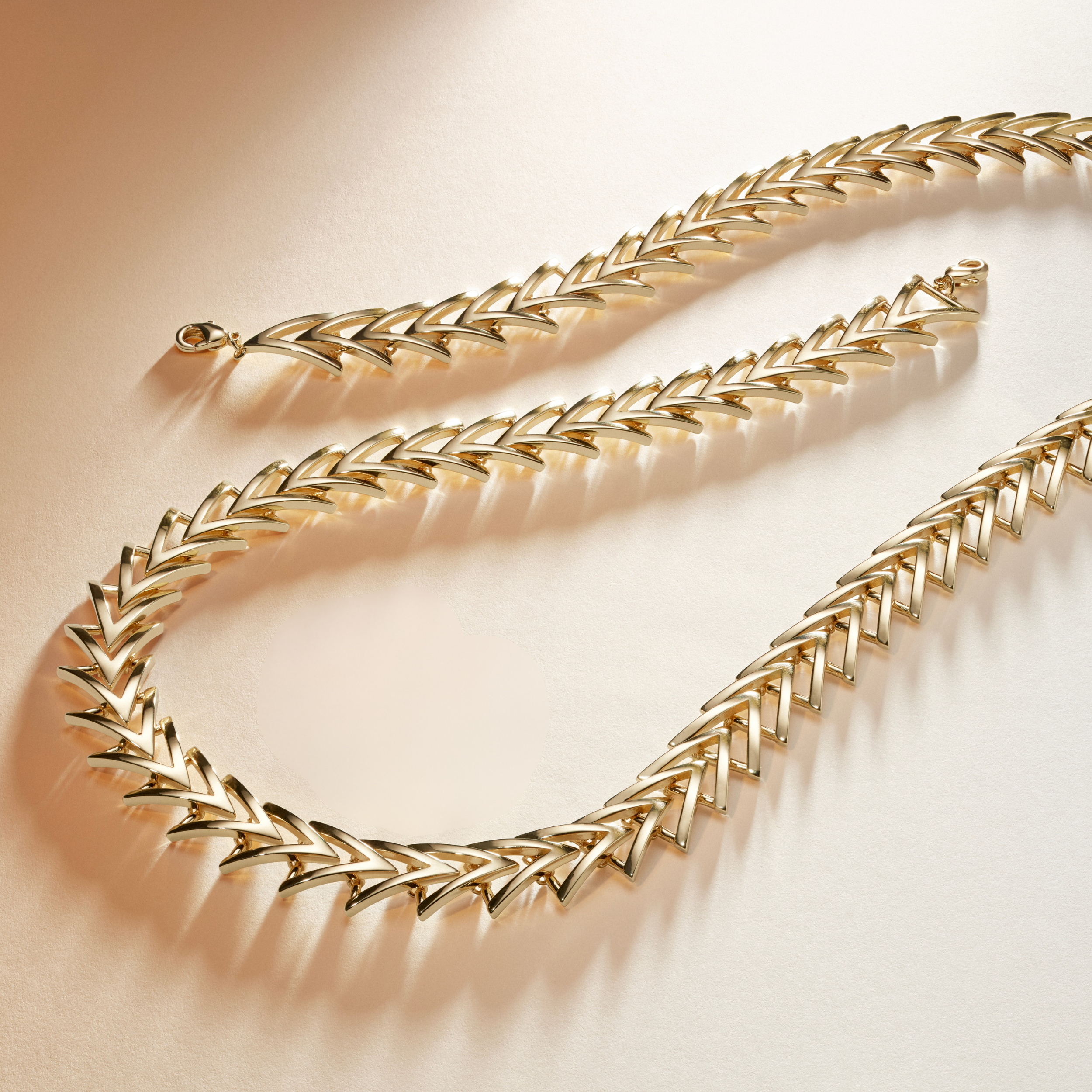 Armine + Ambrose A Chain Gold necklace and bracelet on a beige background