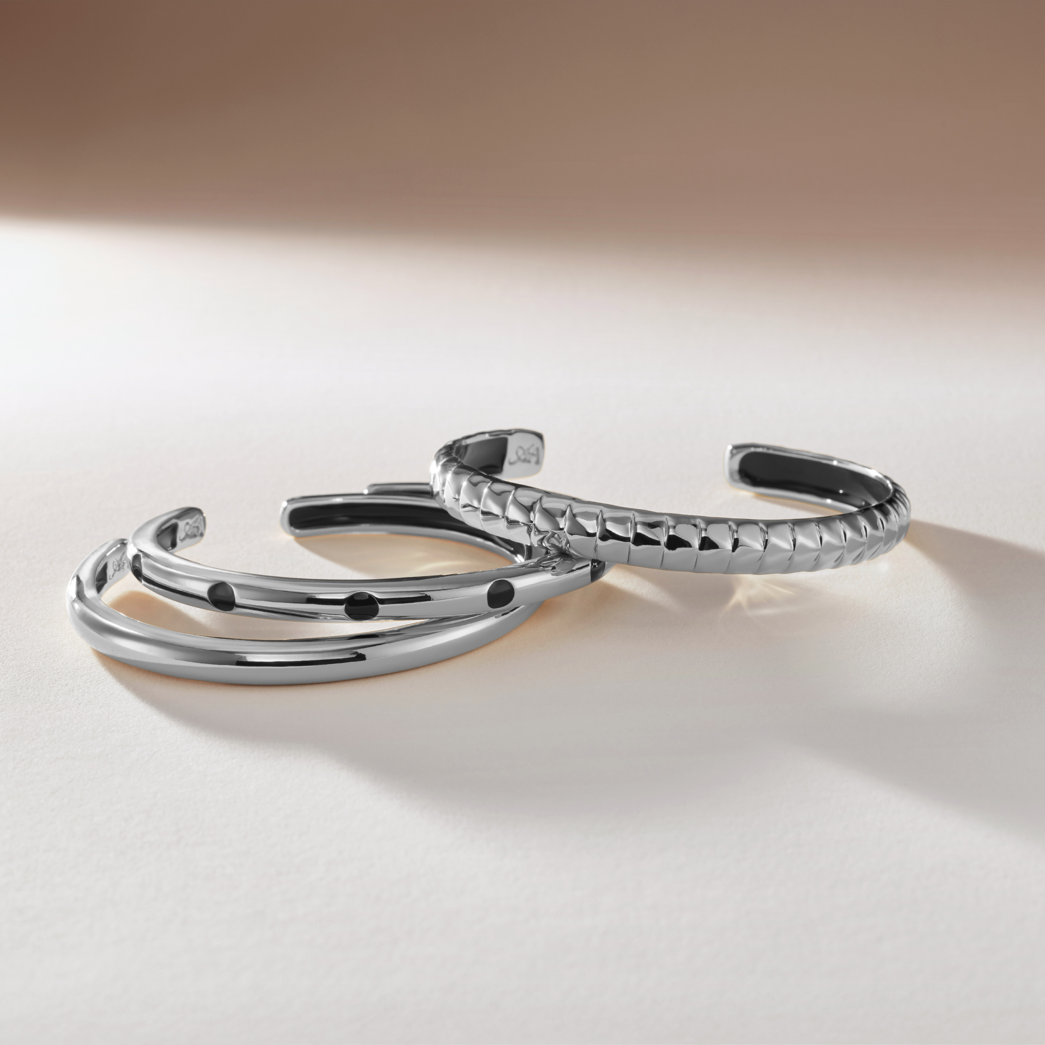 Silver bracelet on a light beige background