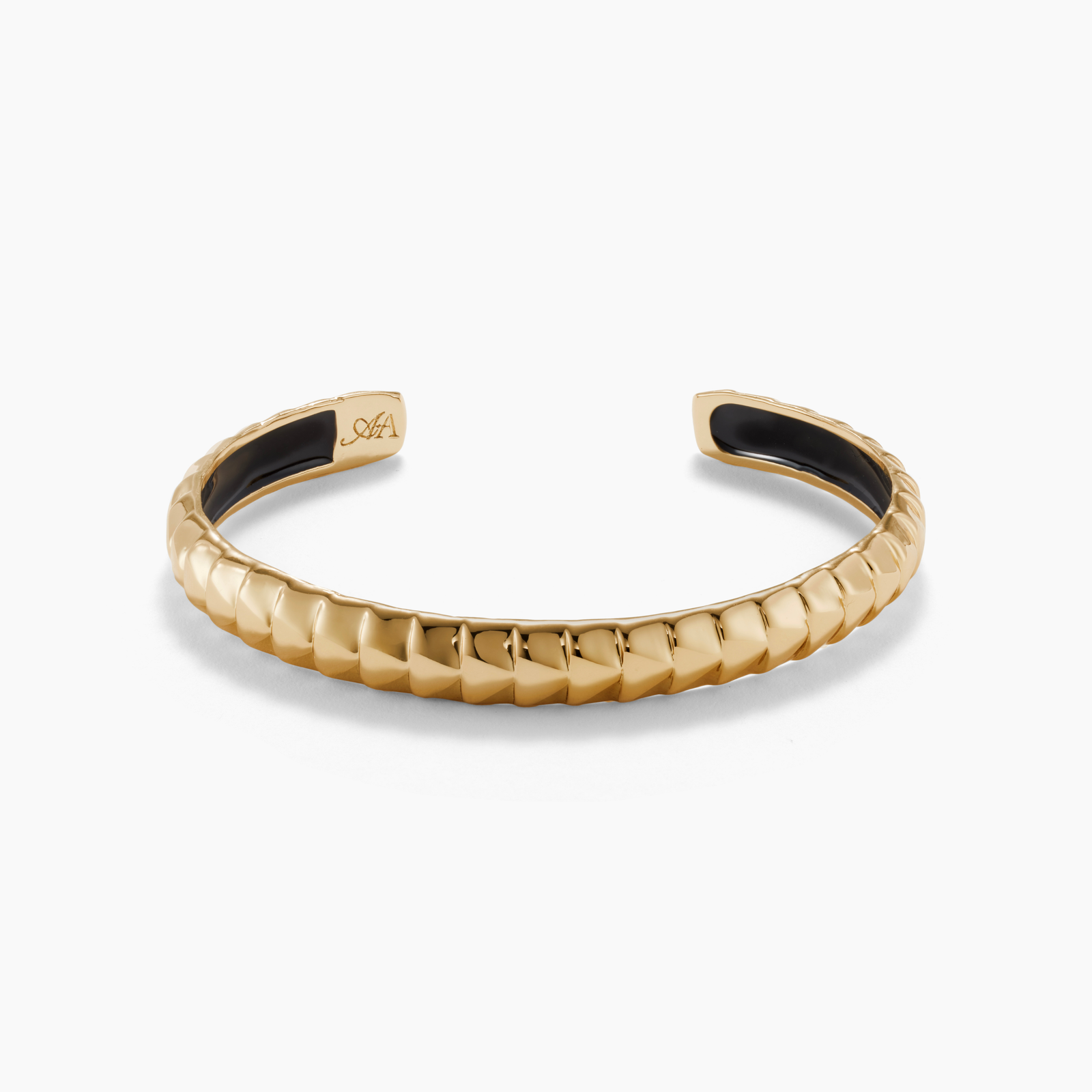 Gold bracelet with black interior on a white background