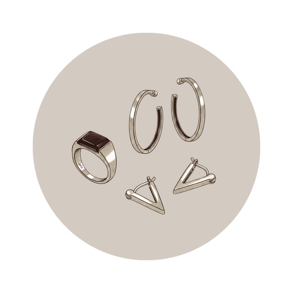 Set of silver rings on a beige circular background