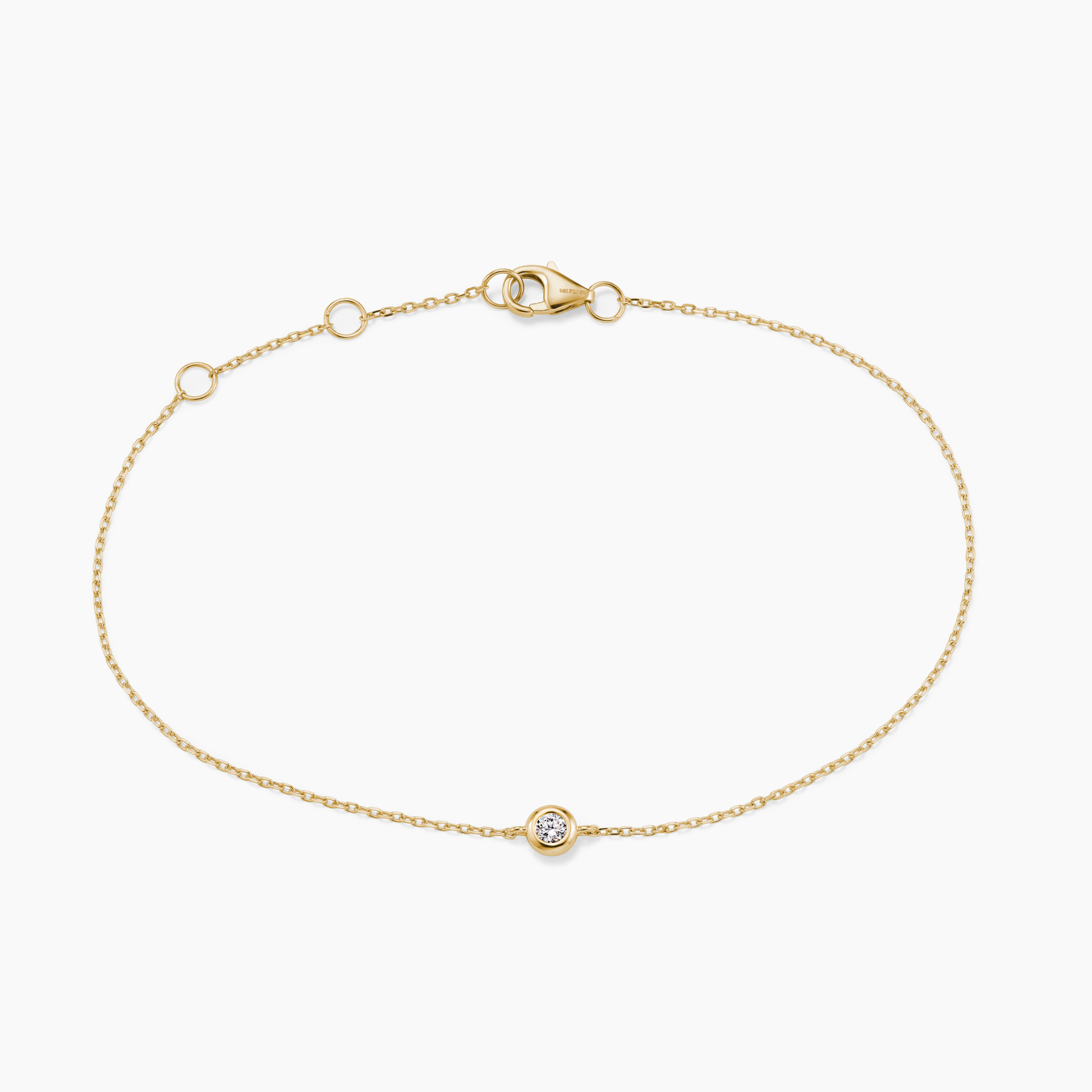 Gold bracelet with a small round diamond on a white background