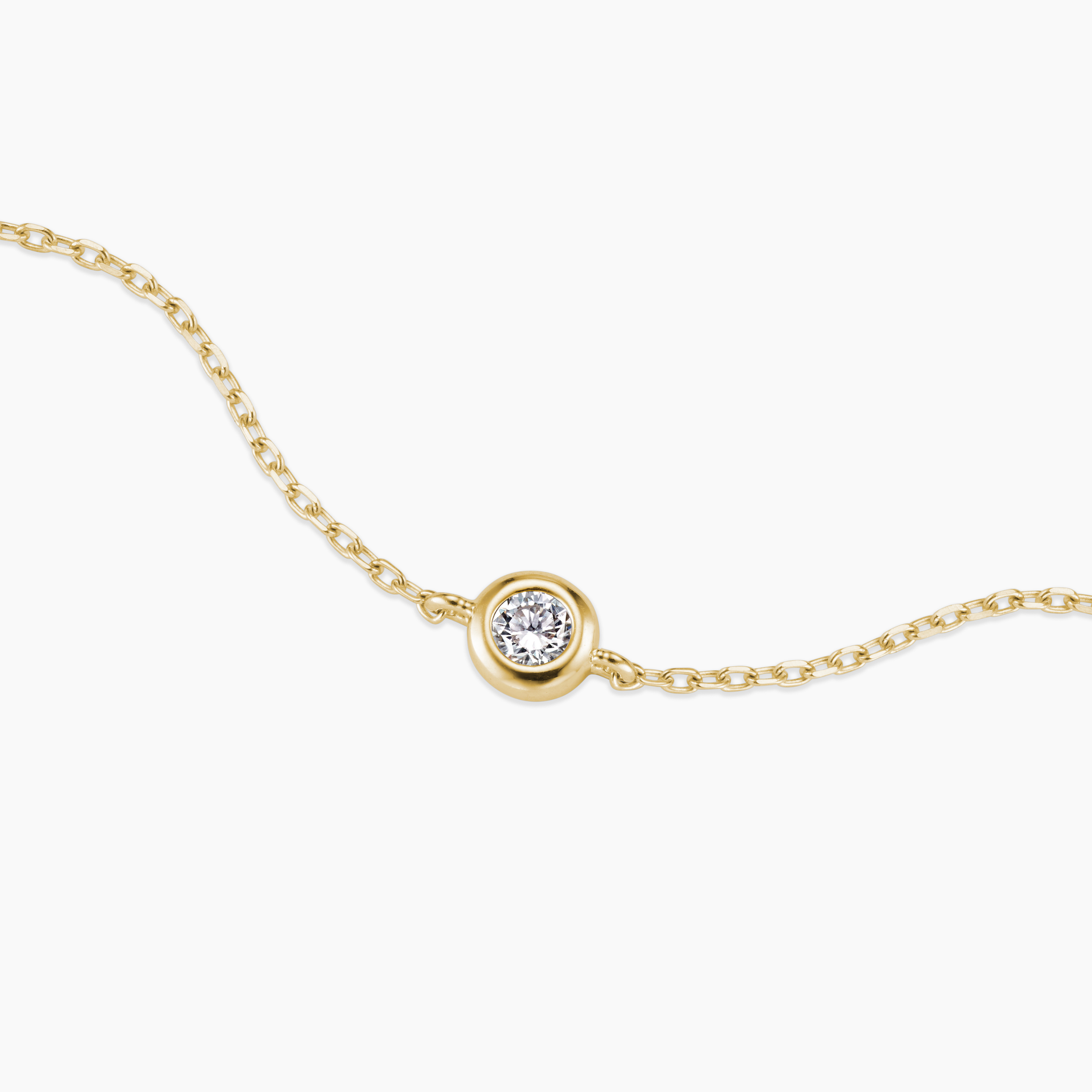 Gold necklace with a single diamond pendant on a white background