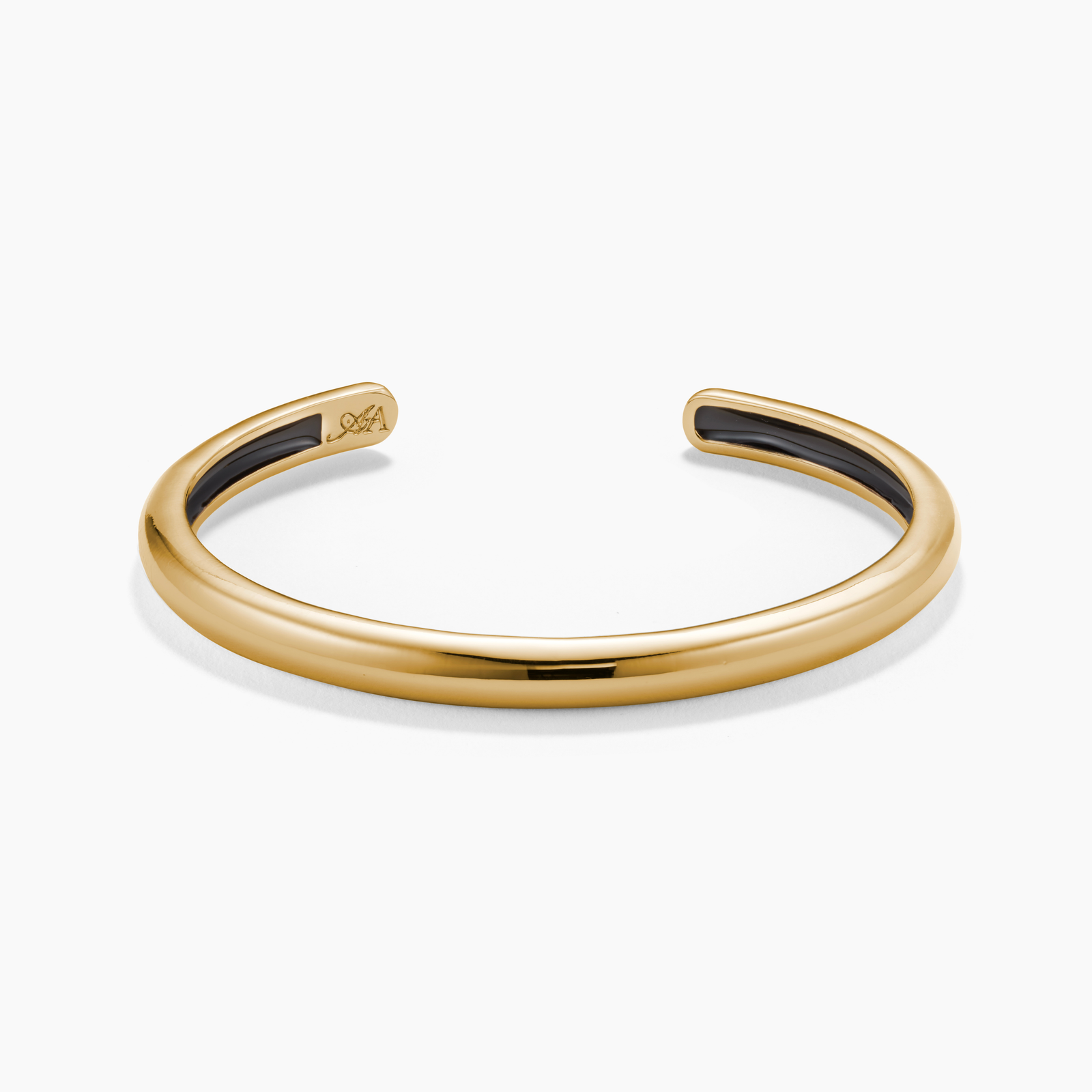 Gold bracelet with black interior on a white background
