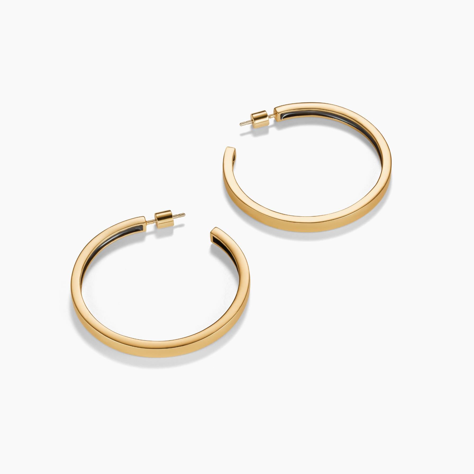 Gold hoop earrings on a white background