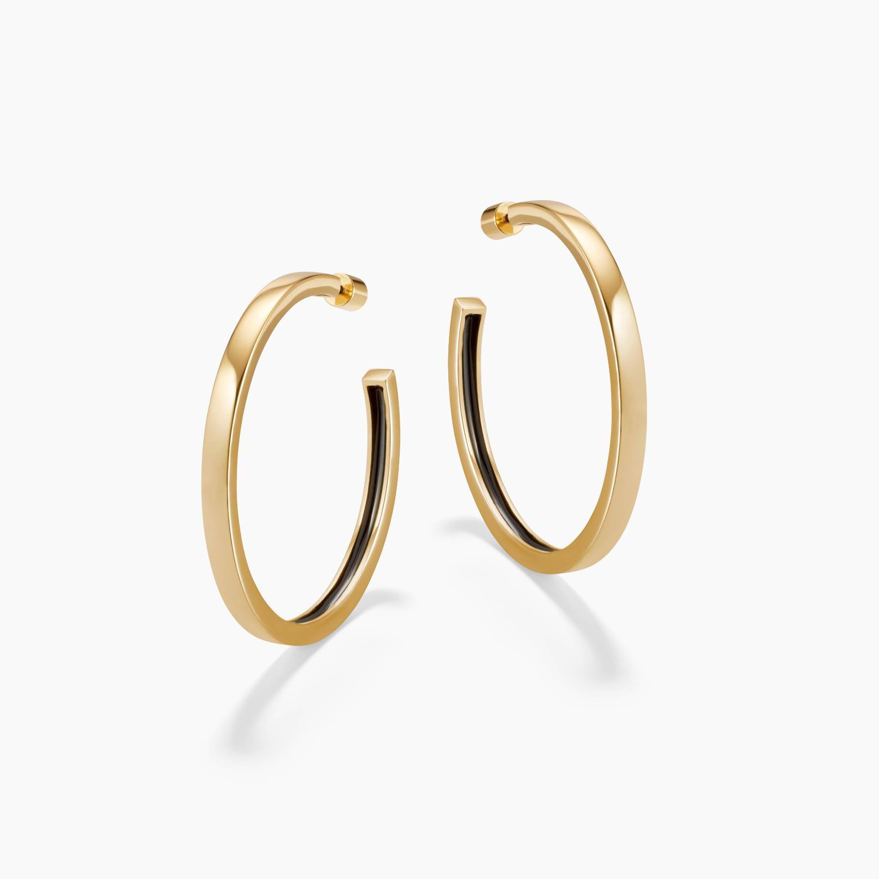 Gold hoop earrings on a white background