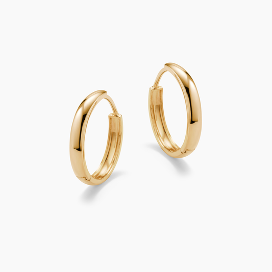GOLD HOOP EARRINGS ON A WHITE BACKGROUND