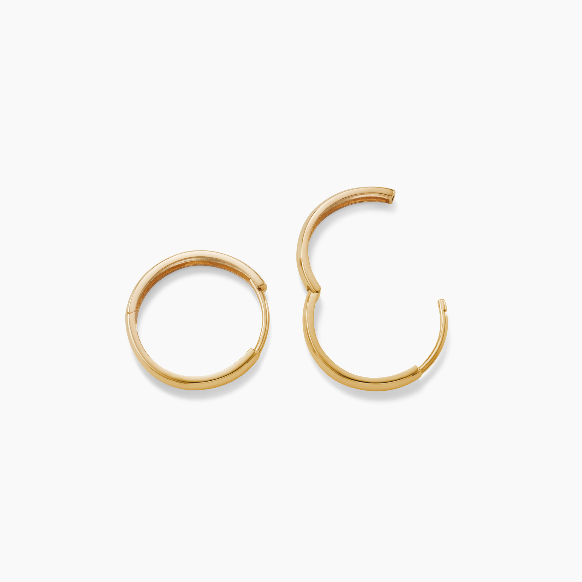 Gold hoop earrings on a white background