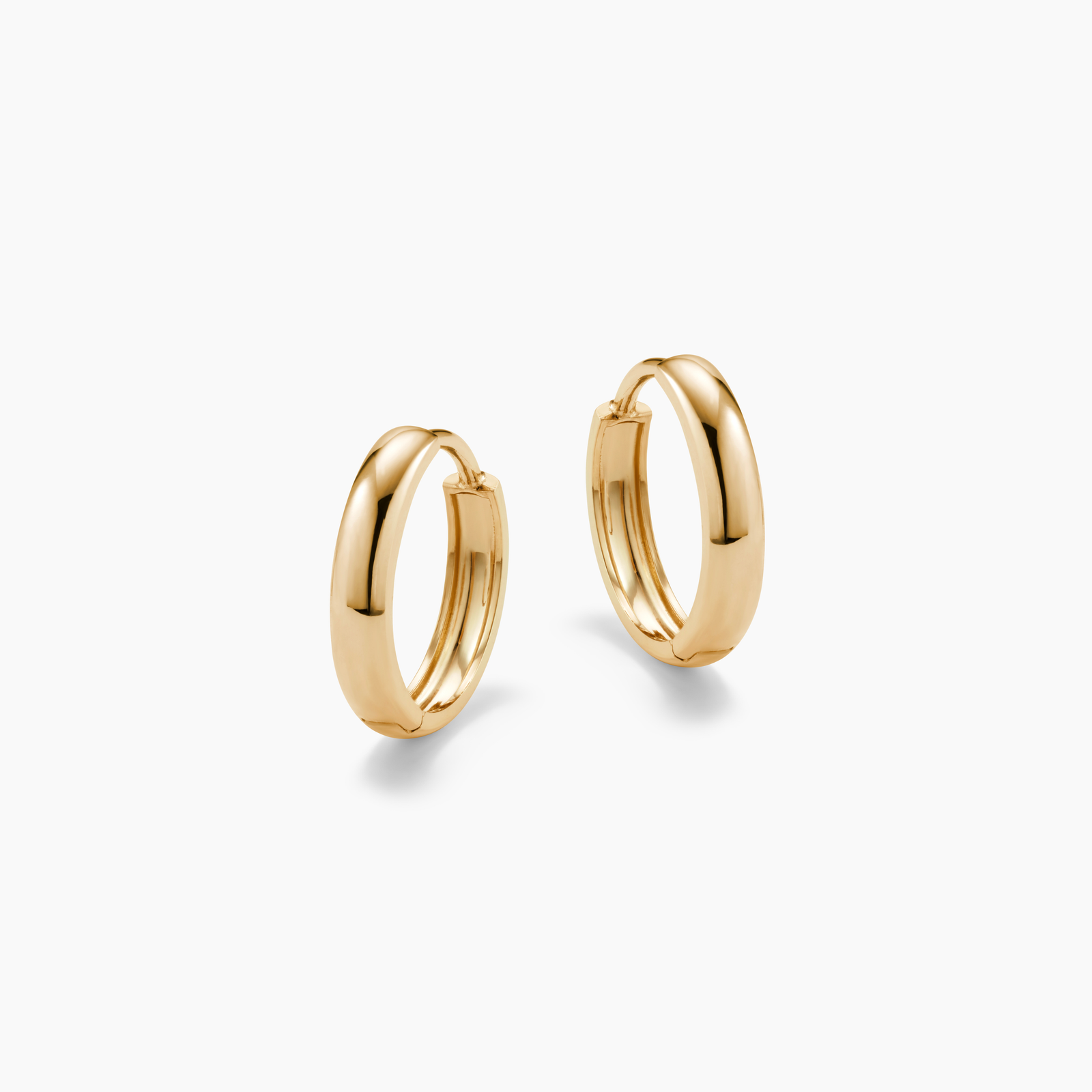 Gold hoop earrings on a white background