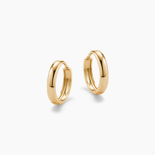 GOLD HOOP EARRINGS ON A WHITE BACKGROUND