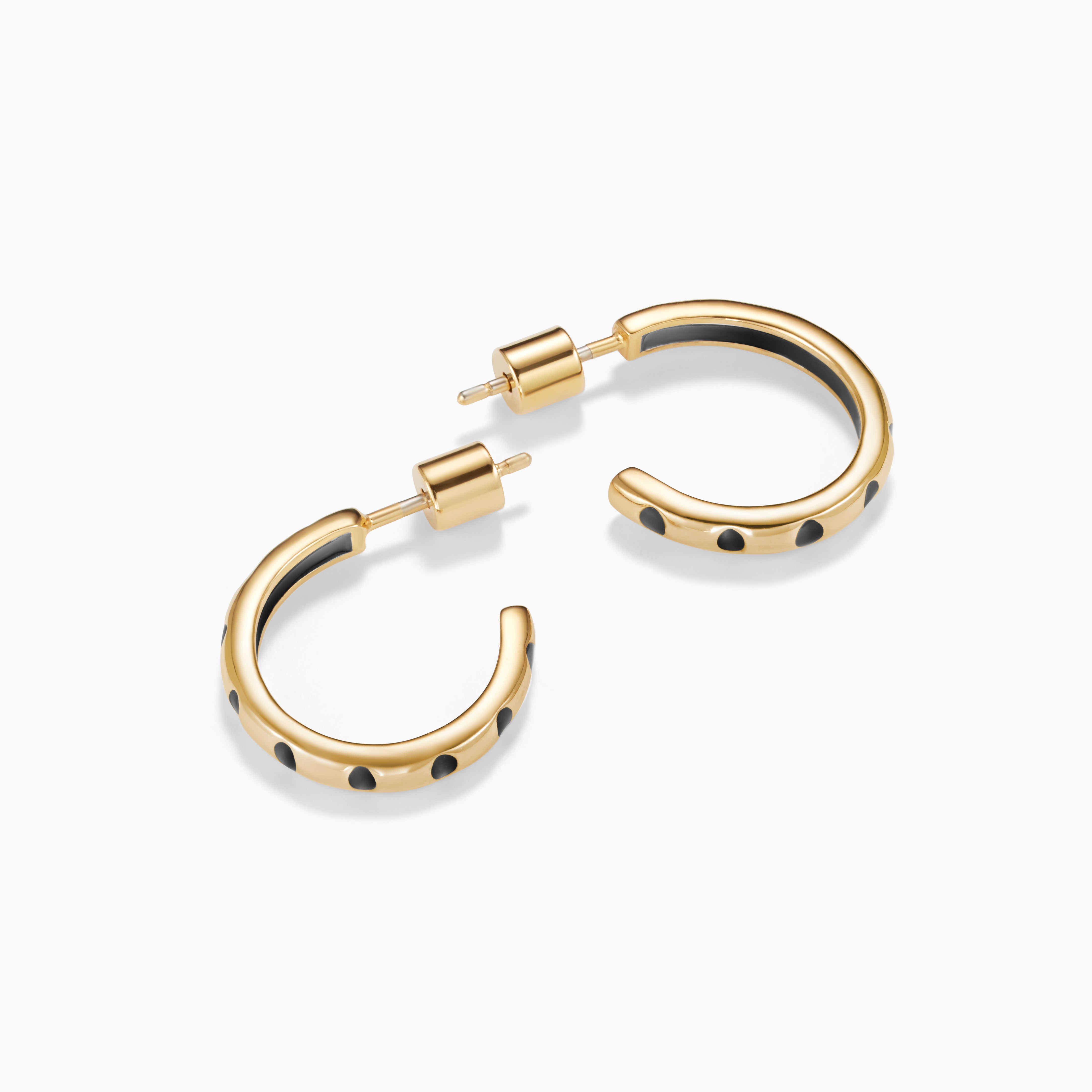 Gold hoop earrings with black accents on a white background